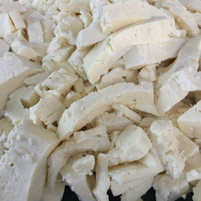 Cheese curds pressed and salted before they are cloth bound and aged. These are fresh pieces of cheese that melt well and have a well rounded flavour.