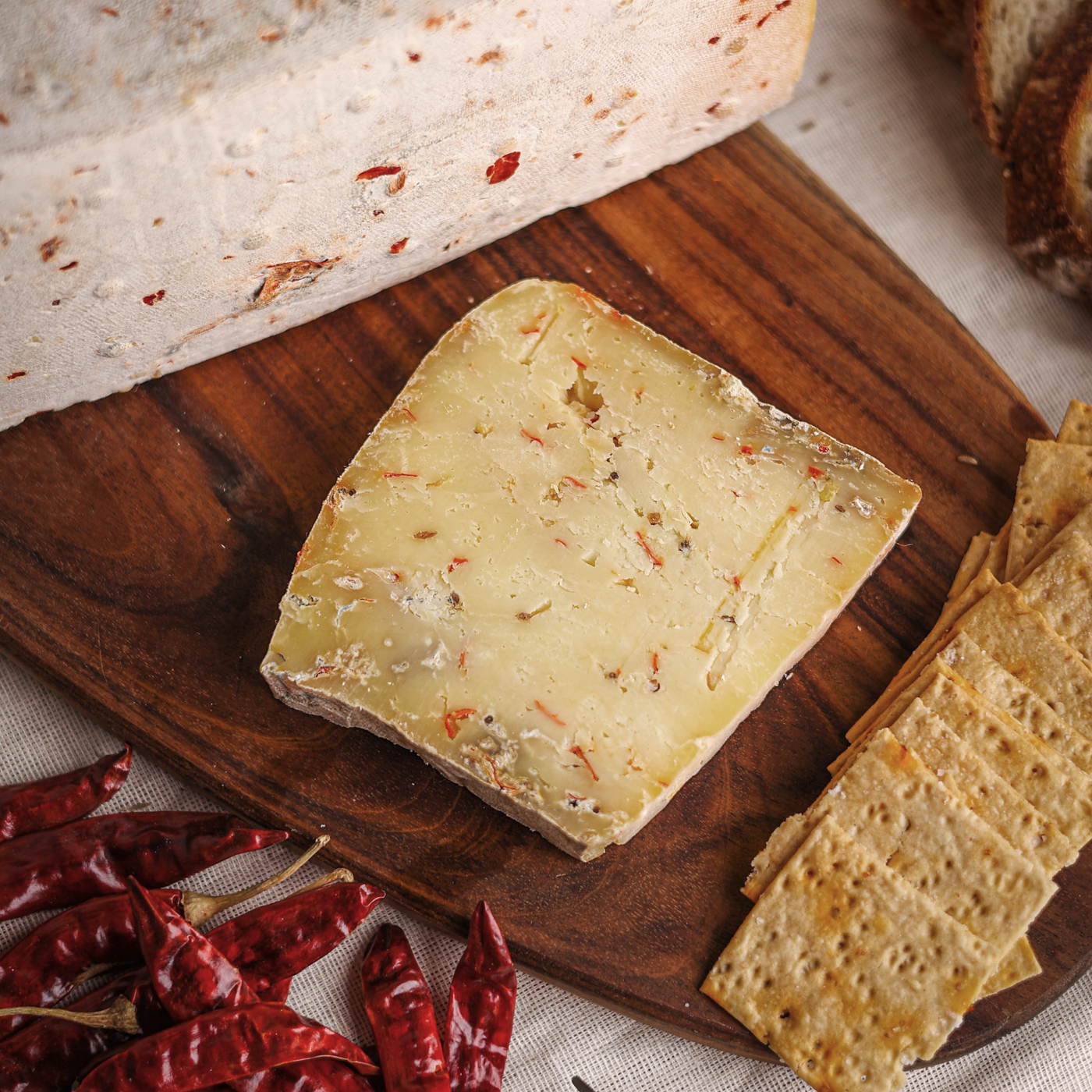 Käse Cumin & Chilli cheese is a semi-hard milled curd cheese infused with cumin & chili and aged for 6-8 months.